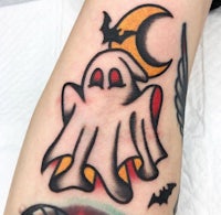 a tattoo of a ghost with a crescent moon