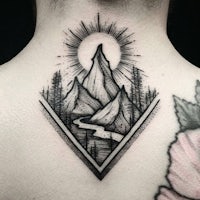 a black and white tattoo of mountains and flowers on the back of the neck